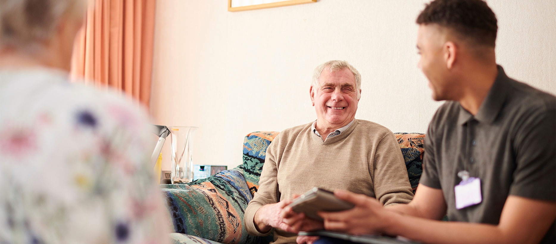 photo of a long-term care social worker with two elderly clients