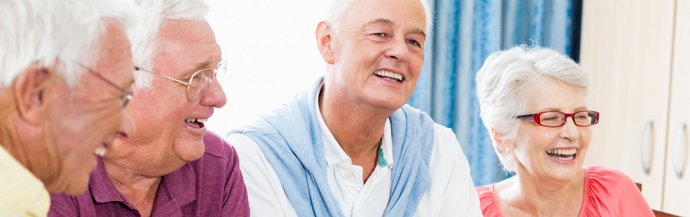 group of elderly friends laughing together